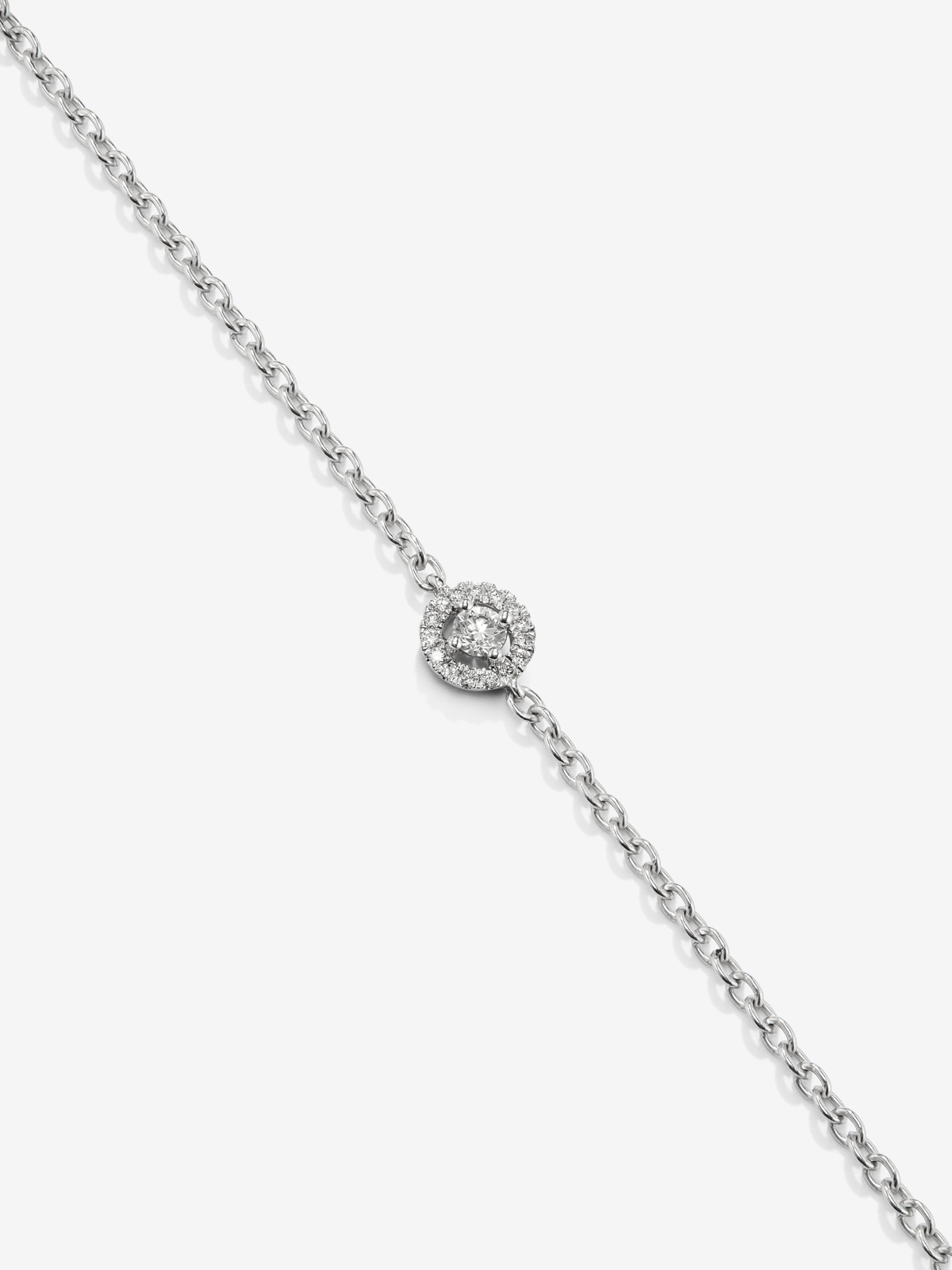 18K white gold chain bracelet with solitary diamond and diamond halo.